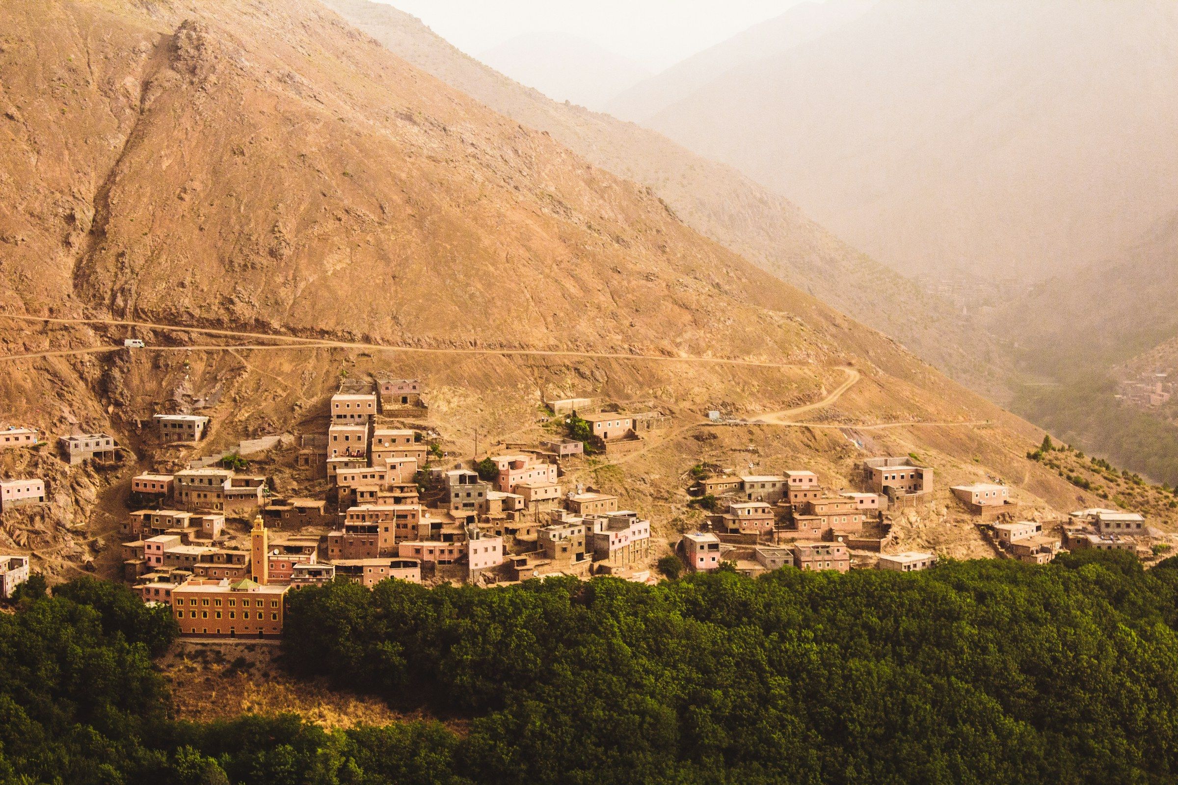 A hillside village above a green valley